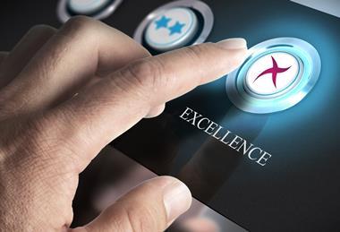 A finger on an 'excellent' button on a keypad